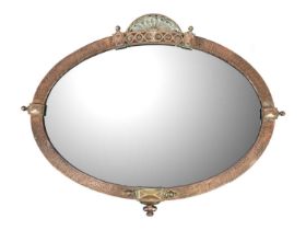A planished copper oval wall mirror.