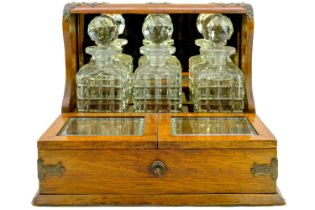 A late Victorian oak tantalus and cigar cabinet.