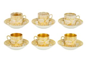 A set of six gilt decorated coffee cans and saucers.