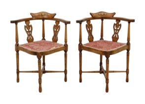 A pair of Edwardian mahogany and inlaid corner chairs.