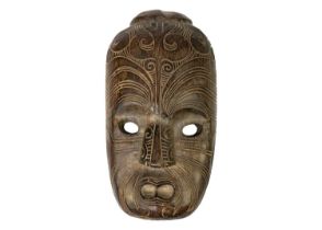 A wood carved Maori mask.