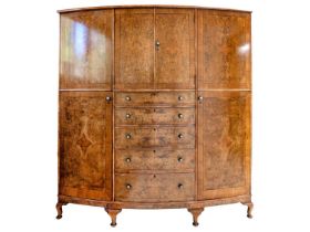 A burr walnut and crossbanded bow front wardrobe.