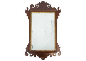 A George III mahogany fretwork wall mirror.