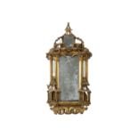 A George III gilt gesso and carved wood wall mirror.