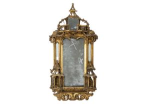 A George III gilt gesso and carved wood wall mirror.