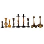 A collection of nine treen candlesticks.