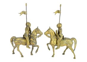 A pair of brass knights on horseback.