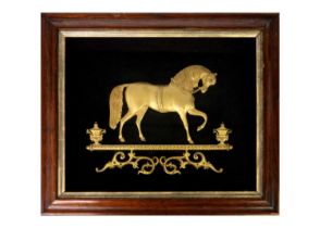 A Victorian gilt metal relief picture of a horse.