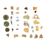 A group of Cypriot pottery shards and glass fragments.