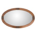 An Arts and Crafts copper frame oval mirror.