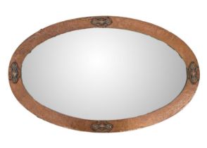 An Arts and Crafts copper frame oval mirror.