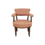 A Victorian walnut upholstered tub chair.