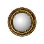 A Circular gilt plaster convex wall mirror.