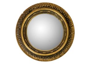 A Circular gilt plaster convex wall mirror.
