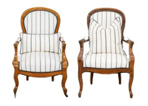 Two matched French walnut upholstered fauteuil armchairs.