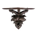 A Black Forest carved wall bracket.