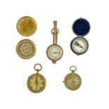 A collection of five compasses.