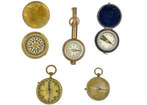 A collection of five compasses.