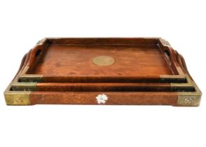 A set of three graduated Chinese hardwood and brass trays.