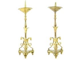 A pair of brass pricket type ecclesiastical candlesticks.