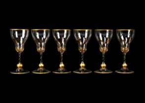 A set of six gilt decorated sherry glasses.
