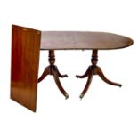 A Regency style brass inlaid mahogany D-end dining table.