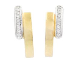 An 18ct yellow and white gold diamond set pair of stud and clip back earrings.