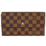 LOUIS VUITTON - A Damier Ebene Sarah wallet.