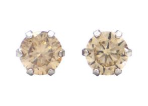 A pair of 18ct white gold diamond set solitaire stud earrings.