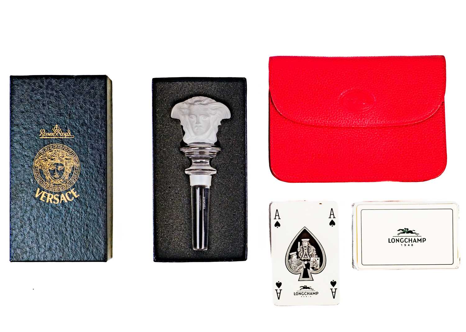 A Longchamps cased set of playing cards and a Rosenthal for Versace glass bottle stopper.