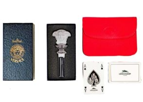 A Longchamps cased set of playing cards and a Rosenthal for Versace glass bottle stopper.