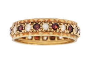 A 9ct garnet and white stone set full eternity ring.