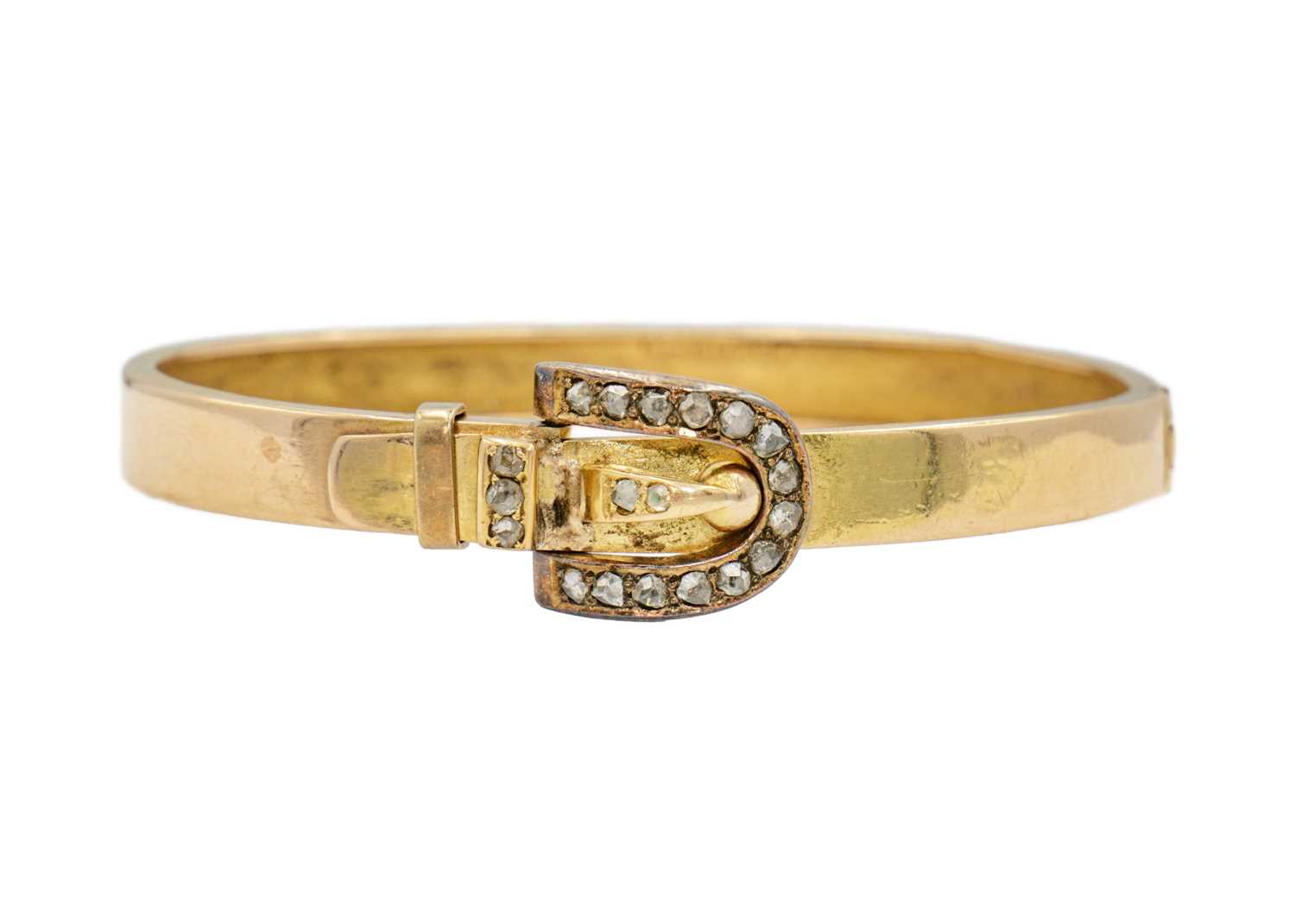 A Victorian gold hinged bangle diamond set with a buckle design clasp, signed DENIS BRO.