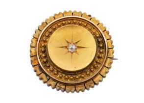 A Victorian Etruscan Revival high purity gold diamond set brooch.