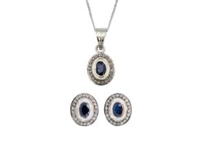 A diamond and blue sapphire, silver set, earring and pendant necklace suite.