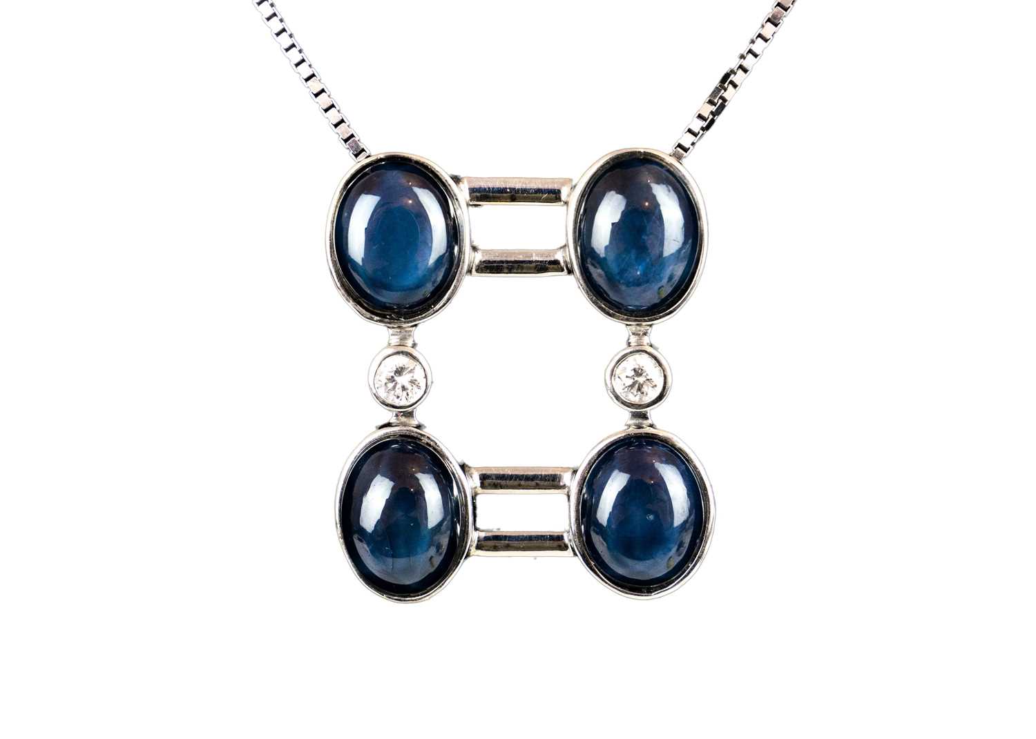 An 18ct white gold contemporary star sapphire and diamond set pendant necklace.