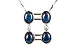 An 18ct white gold contemporary star sapphire and diamond set pendant necklace.