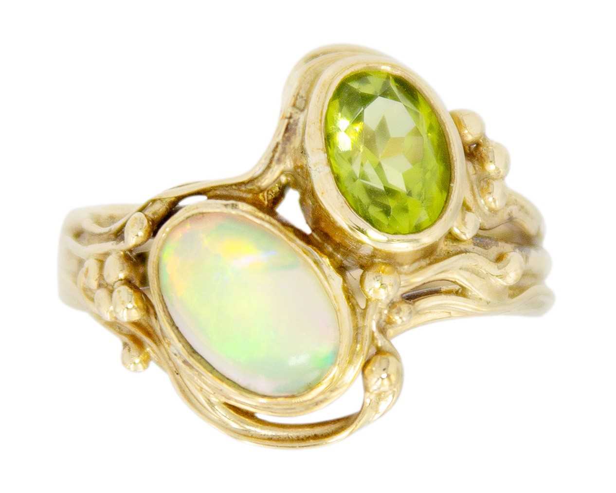 A 9ct Art Nouveau style opal and peridot set dress ring.