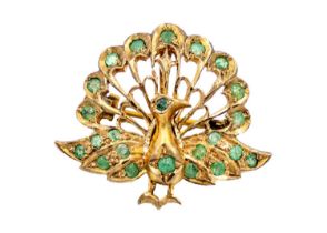 An Indian gilt metal emerald set peacock design brooch pendant.