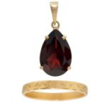 An 18ct band ring and a 9ct garnet set pendant.