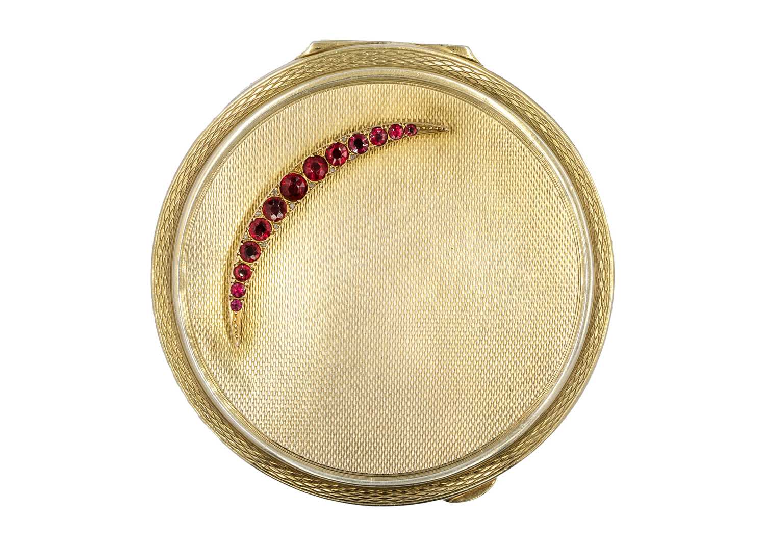 A modern silver gilt compact applied with a 9ct garnet and diamond crescent.