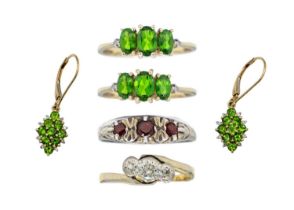 Four gem set rings and a pair of gem-set pendant earrings.