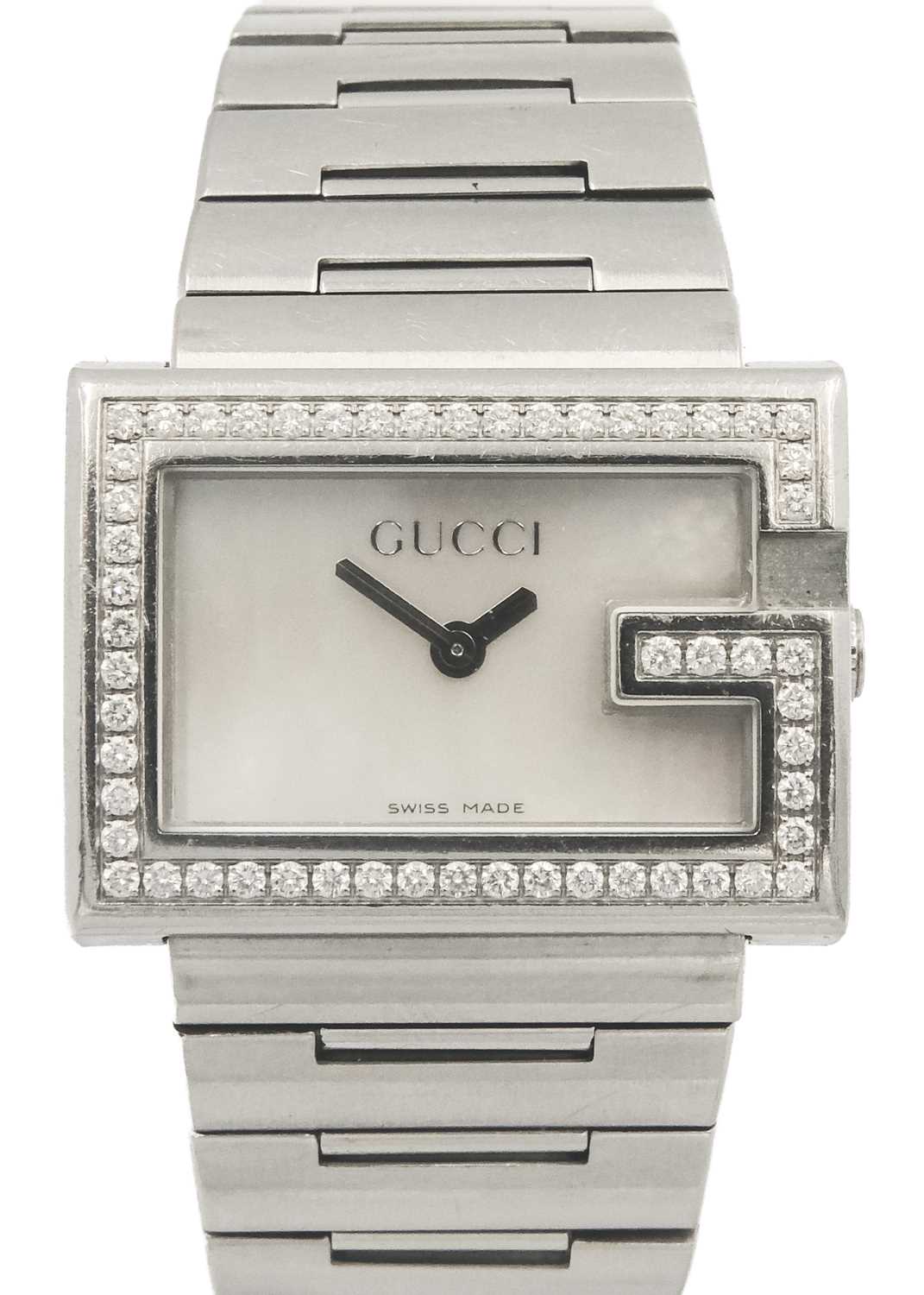 A Gucci lady's stainless steel diamond set quartz bracelet wristwatch.