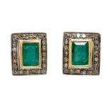 A pair of silver and silver gilt emerald and diamond set cufflinks.