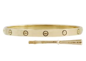 CARTIER - An 18ct love bangle with a screwdriver and original box and bag.