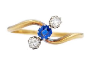 An attractive early 20th-century 18ct diamond and sapphire set three-stone twist design ring.