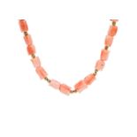 A carved coral bead necklace with gold ball spacers and 9ct clasp.
