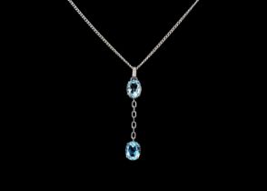 An 18ct white gold blue topaz and diamond set pendant necklace.