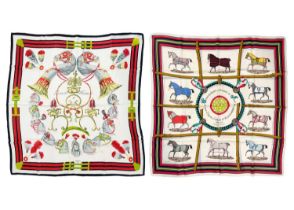 HERMES - Two equestrian printed silk scarves.