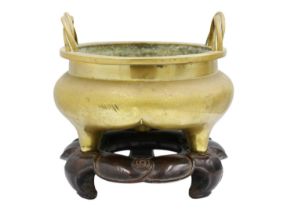 A large Chinese bronze twin-handled tripod censer on stand, Qing Dynasty.